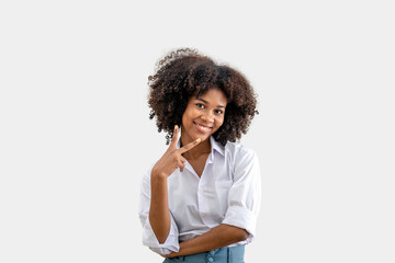 Fototapeta na wymiar A young black woman smiling holds up two fingers. isolated on a white background. two sign , Positive human emotion.