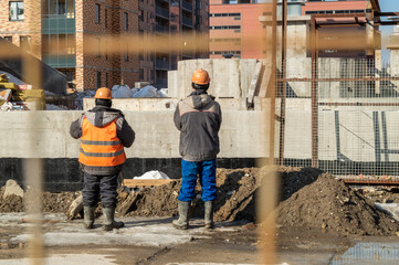 builders on the construction site. view from the back