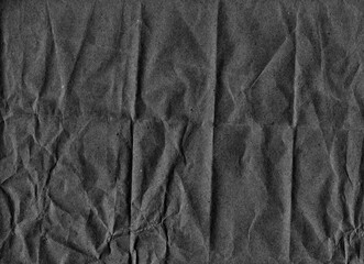Dark gray crumpled paper with texture of noise, scratches, dust