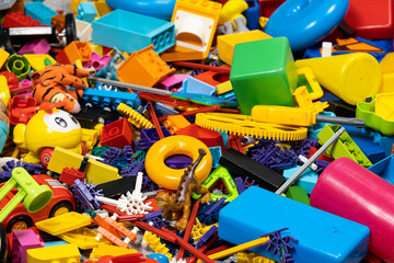 An abundance of toys in the children's room, a lot of plastic multi-colored parts from designers,...