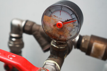 Damaged manometer. Bad pressure gauge in the pipeline. Metallic pressure sensor.