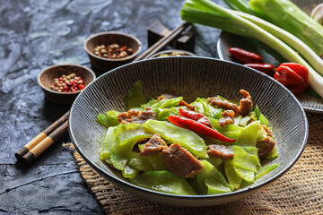 Celtuce (stem lettuce, Lactuca sativa var augustana ) stir fried with some meat and spices on table...