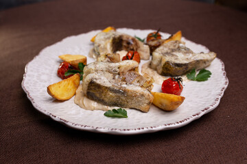 fish dishes. pieces of fish with potatoes on a plate
