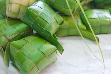 Ketupat (rice dumpling) over the white cloth for the Eid Mubarak festival. Weave or plait the ketupat using young coconut leaves.