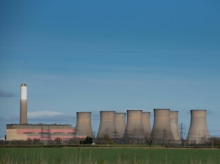 Scenic image of a nuclear power plant with several cooling towers visible in the background