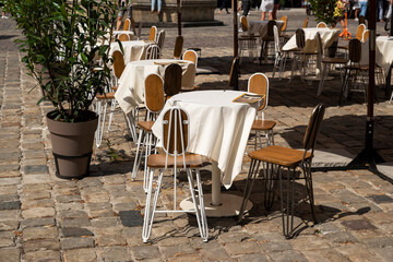 tables with a tablecloth and chairs on a summer terrace in a cafe