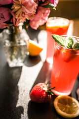 delicious and refreshing sangria, packed with juicy fruit near a bouquet of fresh peonies