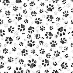Black gray doodle paw prints and black bones. Seamless fabric design pattern