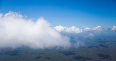 An airplane view of clouds symbolizes freedom, imagination, and perspective. The vast expanse of the sky inspires awe and wonder, offering a sense of detachment from the daily grind 