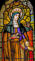 Fototapeta na wymiar Saint Elizabeth of Hungary stained glass, Phoenix, Arizona. Saint Elizabeth of Hungary former queen became nun. Church rebuilt stained glass 1915