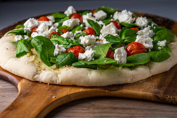 Uncooked gourmet vegetarian pizza, homemade.