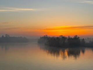 Fototapeta na wymiar fog and dawn over the river in the early morning
