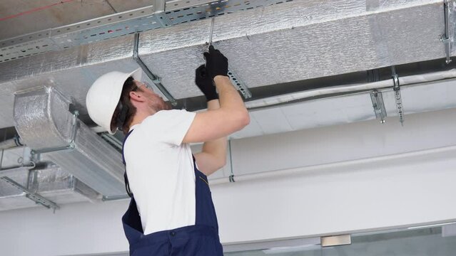 Ventilation system installation and repair service. Hvac technician at work