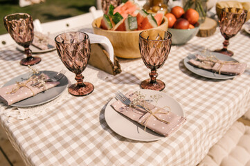 rustic birthday decor on the street, table setting with fruits, beautiful dishes and flowers