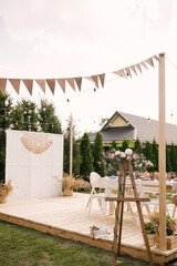 rustic outdoor birthday decor, table setting and photo zone