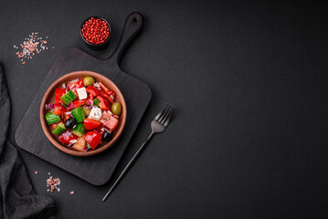Delicious, fresh Greek salad with feta cheese, olives, tomatoes and cucumbers