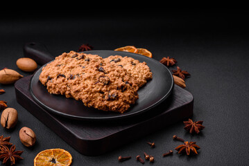 Delicious baked oatmeal raisin cookies on a dark concrete background