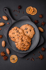 Delicious baked oatmeal raisin cookies on a dark concrete background