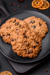Delicious baked oatmeal raisin cookies on a dark concrete background