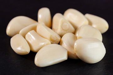 Fototapeta na wymiar Garlic cloves. Raw garlic isolated on black background. Vegetable