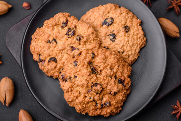 Delicious baked oatmeal raisin cookies on a dark concrete background