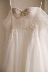 Beautiful delicate luxurious wedding dress of the bride is embroidered with beads, rhinestones and precious stones