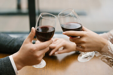 glasses of wine in hands of a couple in love