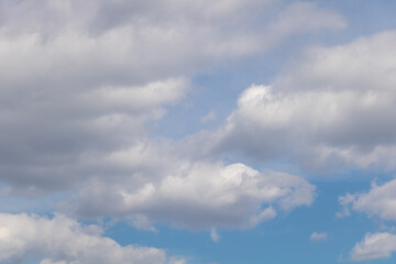 Blue sky with white clouds. Clouds in the blue sky background