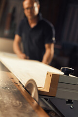 Man works with circular saw