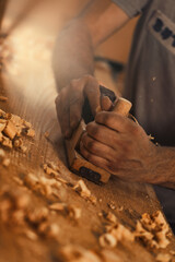 Carpenter Produces golden curls of sawdust