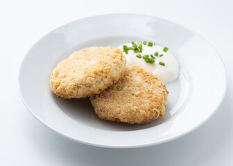 fish cutlet with sour cream on a white background
