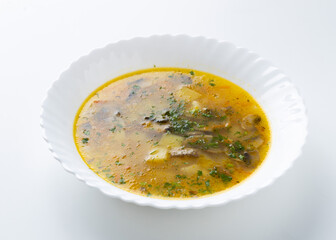 mushroom soup in a white plate on a white background
