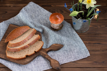 black bread sliced on a wooden cutting board. Rustic style