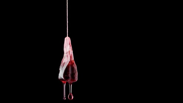 Single used teabag with tea flowing in slow motion