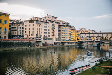 Fototapeta na wymiar Looking out at the Arno River and Ponte Vecchio in Florence, Italy at Sunset