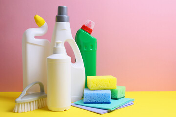 A set of different cleaning and disinfectant products on a coloured background