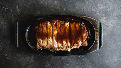 Appetizing steak cut into slices with sauce. Meat close-up.