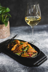 Appetizing grilled vegetables sprinkled with herbs in a flat pan