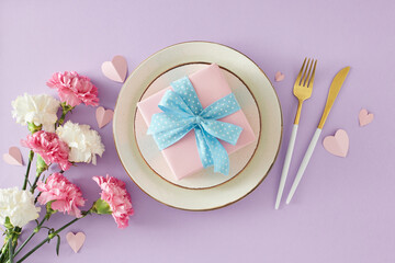 Fototapeta na wymiar Happy Mother's Day mood concept. Top view photo of plate and gift box cutlery bunch of pink white carnation flowers and paper hearts on violet background