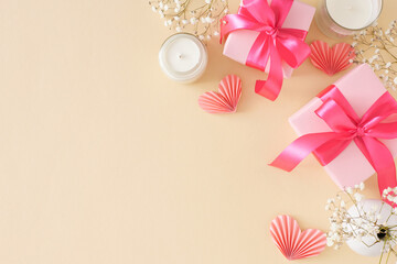 Modern Mother's Day celebration concept. Top view photo of gift boxes with bows candles gypsophila...