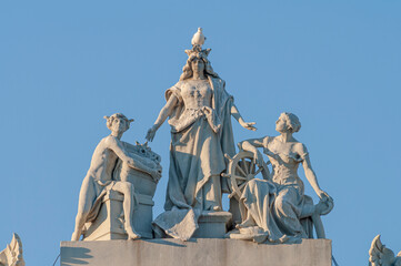 Obraz premium Barcelona, Spain – Port historic authority building with statues at the harbor in the famous walking, dining and shopping downtown of Barcelona at susnset colors