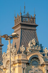 Barcelona, Spain – Port historic authority building with statues at the harbor in the famous walking, dining and shopping downtown of Barcelona at susnset colors