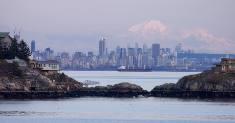Cabins on Passage Island with Downtown City Buildings and Mnt Baker in Background. Vancouver, British Columbia, Canada.