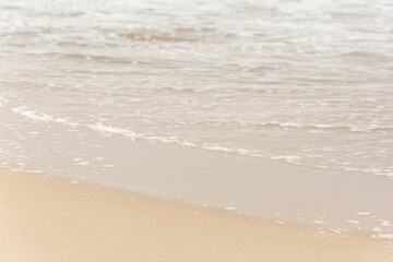Waves breaking on the shore at the beach