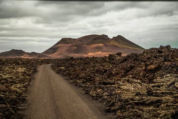 Selbstklebende Fototapete Kanarische Inseln Amazing panoramic landscape of volcano in Timanfaya national park. Popular touristic in Lanzarote island Canary islans Spain. Artistic picture. Travel concept