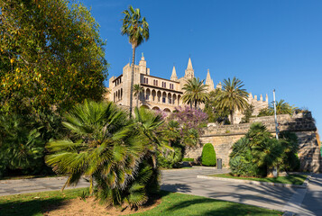 Fototapeta na wymiar Almudaina Palace and Cathedral of Palma de Mallorca (Balearic Islands, Spain) seen from the gardens of s'Hort des Rei, in the centre of the city.