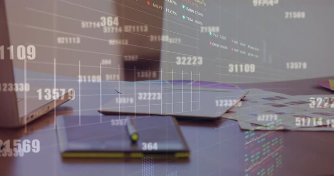 Animation of numbers, graphs, trading boards over laptop dairy, paper and photographs on desk