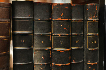 Black retro worn books on a shelf in the library