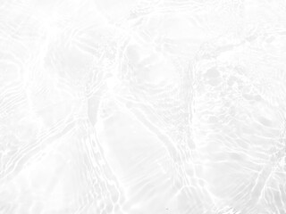 White water with ripples on the surface. Defocus blurred transparent white colored clear calm water surface texture with splashes and bubbles. Water waves with shining pattern texture background.