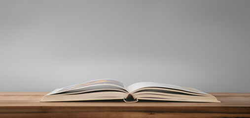 Open book on the table on wood surface. Learn concept.